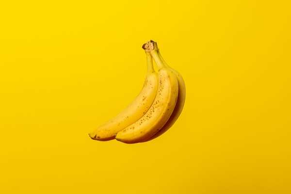 two bananas on a yellow background