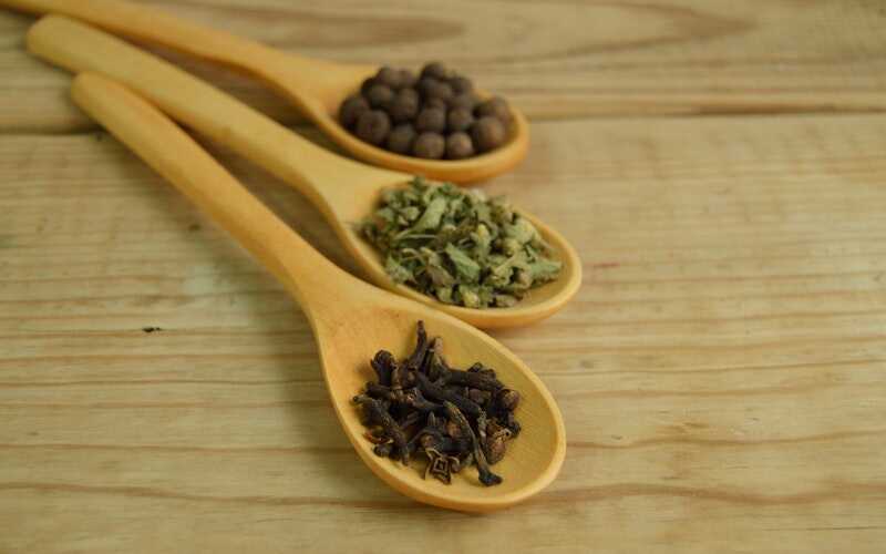herbs in wooden spoons