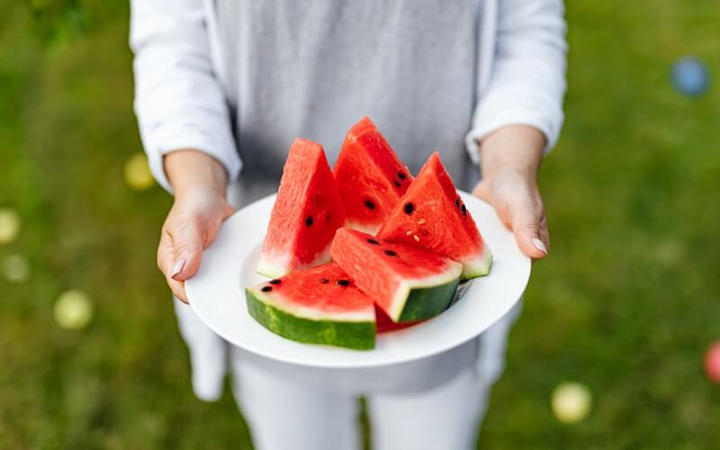 a plate with watermelon cut in pieces